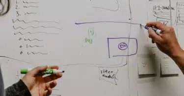 two people drawing on whiteboard